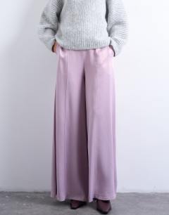 Model wearing Extreme wide leg satin trouser in pink