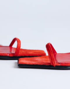 Model wearing Ezra strappy heel sandal in red hair on real leather