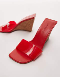 Model wearing Farah high wedge heeled mule in red