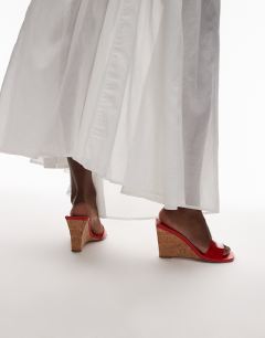 Model wearing Farah high wedge heeled mule in red