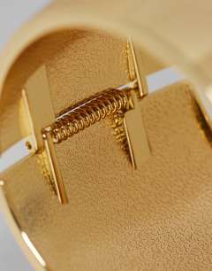 Model wearing Farah oversized bangle in gold tone