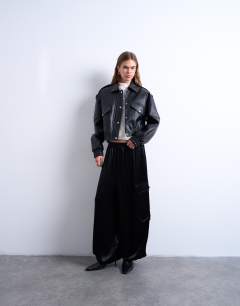 Model wearing Faux bubble leather 80s bomber jacket in black