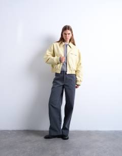 Model wearing Faux bubble leather cropped bomber jacket in buttermilk