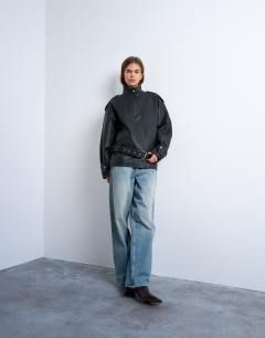 Model wearing Faux bubble leather short belted funnel bomber jacket in black