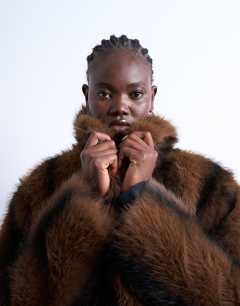 Model wearing Faux fur boxy blazer coat in brown stripe