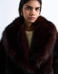 Model wearing Faux fur boxy shawl coat in dark burgundy