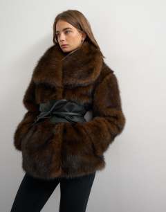 Model wearing Faux fur coat with faux leather belt in brown