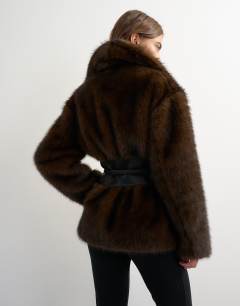 Model wearing Faux fur coat with faux leather belt in brown