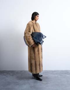 Faux fur collarless long coat in natural stripe