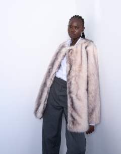 Model wearing Faux fur collarless mid length coat in white stripe