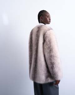 Model wearing Faux fur collarless mid length coat in white stripe