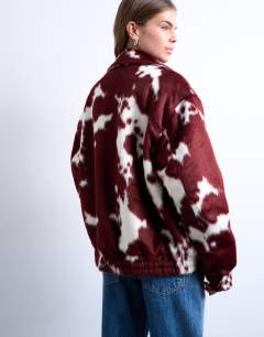 Model wearing Faux fur cow print bomber jacket