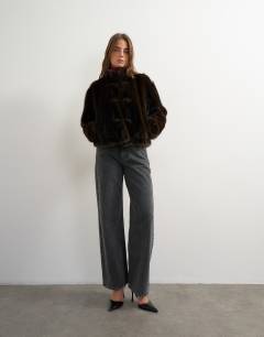 Model wearing Faux fur cropped jacket with knot fastening in dark brown