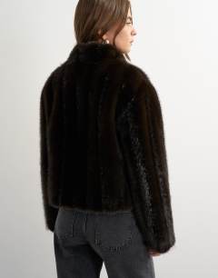 Model wearing Faux fur cropped jacket with knot fastening in dark brown