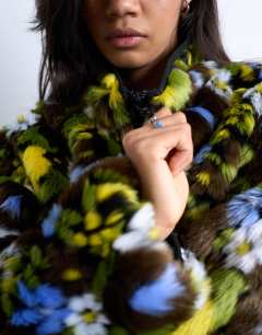 Model wearing Faux fur floral bomber jacket in multi