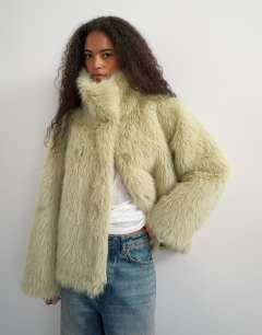 Model wearing Faux fur funnel neck detachable length coat in light green