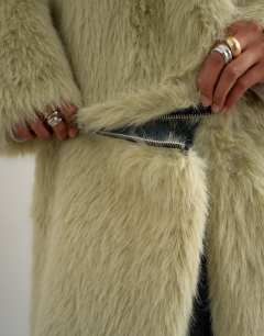 Model wearing Faux fur funnel neck detachable length coat in light green