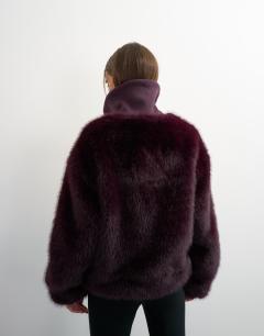 Model wearing Faux fur funnel neck jacket in aubergine