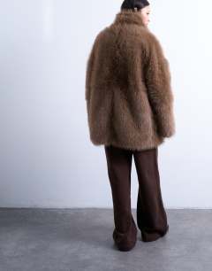 Model wearing Faux fur funnel neck mid length coat in mink