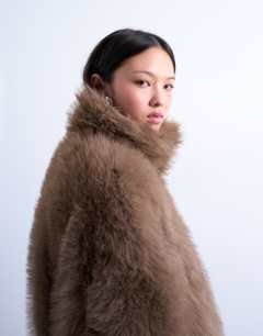 Model wearing Faux fur funnel neck mid length coat in mink