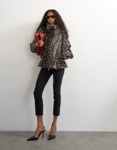 Model wearing Faux fur high neck cinch jacket in brown deer print