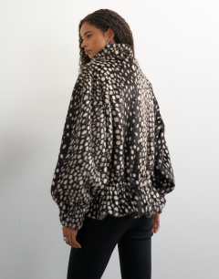Model wearing Faux fur high neck cinch jacket in brown deer print