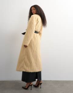 Model wearing Faux fur longline coat with faux leather belt in beige