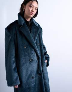 Model wearing Faux fur longline double breasted coat in teal