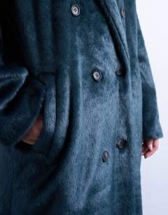 Model wearing Faux fur longline double breasted coat in teal