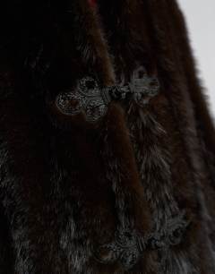 Model wearing Faux fur longline jacket with knot fastening in dark brown