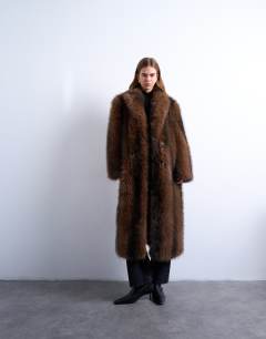 Model wearing Faux fur longline stripe coat in brown