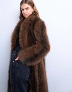 Model wearing Faux fur longline stripe coat in brown