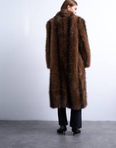 Model wearing Faux fur longline stripe coat in brown