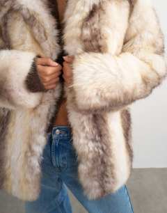 Model wearing Faux fur mid length coat in white stripe