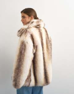 Model wearing Faux fur mid length coat in white stripe