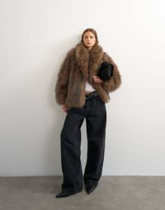 Model wearing Faux fur mid length shawl jacket in light brown