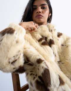 Model wearing Faux fur  pony skin cow print bomber jacket in cream