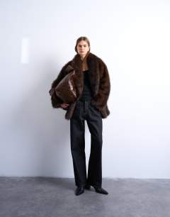 Model wearing Faux fur shawl mid length coat in chocolate