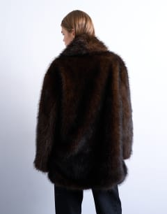 Model wearing Faux fur shawl mid length coat in chocolate
