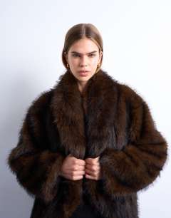 Model wearing Faux fur shawl mid length coat in chocolate