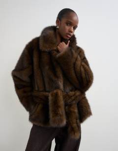 Model wearing Faux fur short belted coat in brown