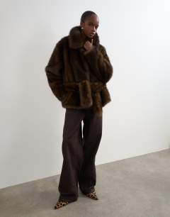 Model wearing Faux fur short belted coat in brown