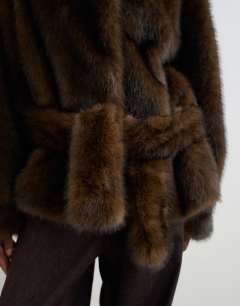 Model wearing Faux fur short belted coat in brown