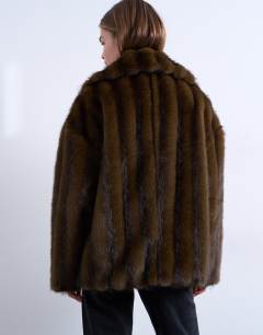 Model wearing Faux fur short car coat in natural stripe