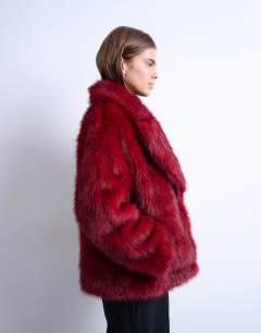 Model wearing Faux fur short jacket with buttons in cherry red