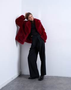 Model wearing Faux fur short jacket with buttons in cherry red