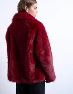Model wearing Faux fur short jacket with buttons in cherry red
