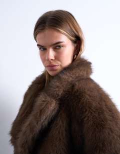 Model wearing Faux fur short jacket with buttons in chocolate