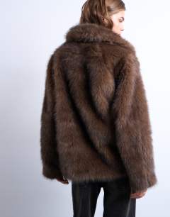 Model wearing Faux fur short jacket with buttons in chocolate
