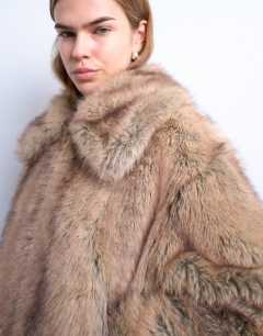 Model wearing Faux fur stripe zip thru bomber jacket in light brown